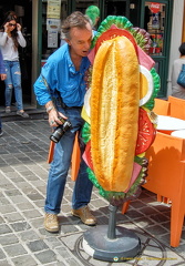 A hungry Tony takes a bite at a sandwich